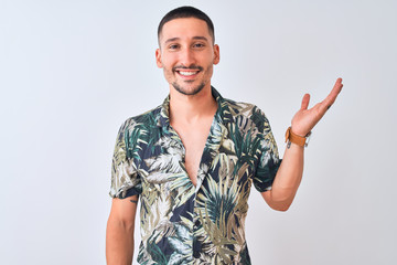 Young handsome man wearing Hawaiian summer shirt over isolated background smiling cheerful...