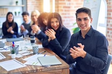 Group of business workers smiling happy and confident. Working together with smile on face looking at the camera applauding at the office
