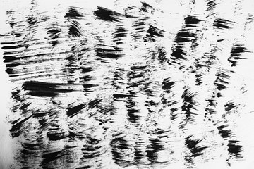 Patterns of black paint from a brush on a white background