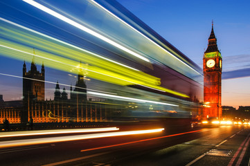 Light trails left by double decker bus passing by Big Ben in London England United Kingdom UK
