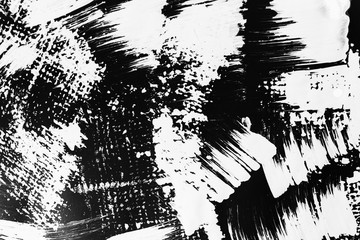 Patterns of white paint from a brush on a black background