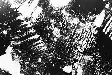 Patterns of white paint from a brush on a black background