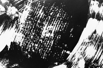 Patterns of white paint from a brush on a black background