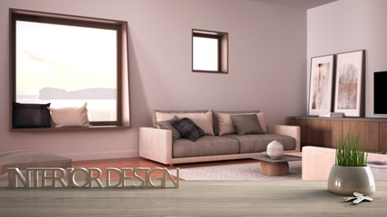 Wooden table, desk or shelf with potted grass plant, house keys and 3D letters making the words interior design, over blurred cosy living room, project concept copy space background