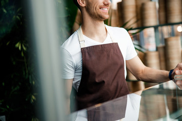 Caucasian bartender is standing near bar counter