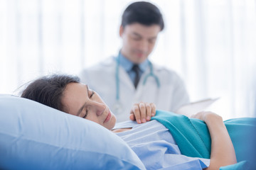Obraz premium A doctor take care of sick patient woman at the hospital or medical clinic.