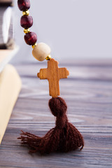 Wooden christian cross on rosary. Close up.