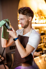 Gentle Caucasian waiter posing for camera indoors