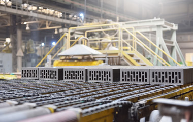 Brick production. New bricks on a conveyor belt at a brick factory. Text space