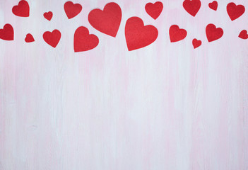 Red hearts on a lilac wooden background