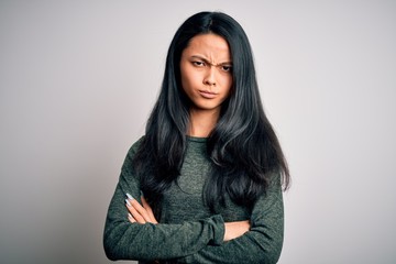Fototapeta premium Young beautiful chinese woman wearing casual t-shirt over isolated white background skeptic and nervous, disapproving expression on face with crossed arms. Negative person.