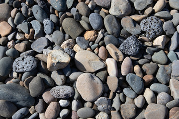 Sea stones background. Gray, white stones on the beach