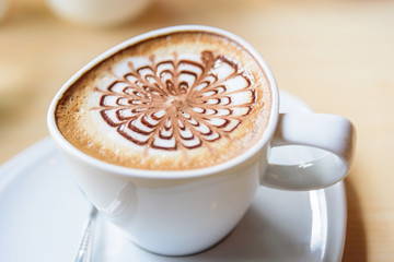 hot cappuccino coffee with nice pattern foam on table