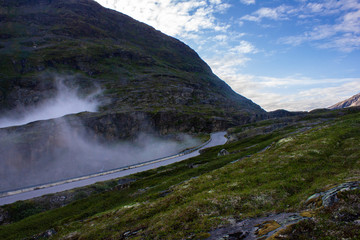 Mountain view and blue sky in the morning in Norway. Fog on the road