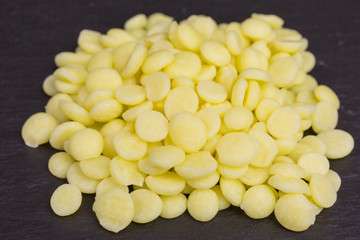 heap of yellow cocoa butter pieces - theobroma oil