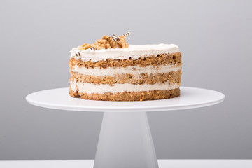 details of tasty conceptual walnut cake, on gray background