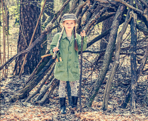 little girl in the wood near the hut