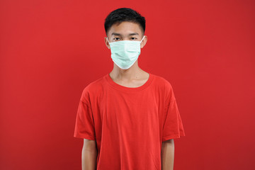 Portrait of  young Asian man wearing protective mask against the coronavirus
