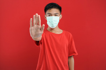 Portrait of  young Asian man wearing protective mask against the coronavirus. Watch out for corona viruses