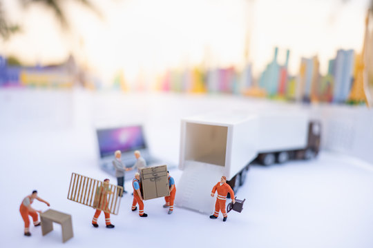 Miniature people: Worker loading box to truck container with copy space using as background business shipping, rent container, worldwide transportation logistic concept.