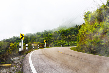 Road in the fog on the way to doi chang, chiang rai.