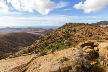 Panoramic view at landscape between Betancuria and Pajara  on Fuerteventura with multi colored volcanic hills and mountains