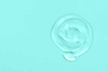 Clear gel drop or smear isolated on light blue background. Copy space.