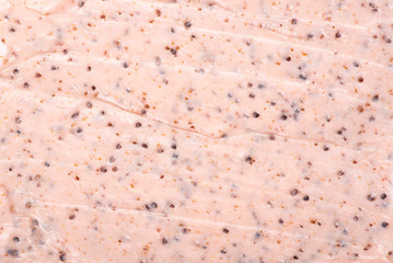 Pink body scrub texture close up.