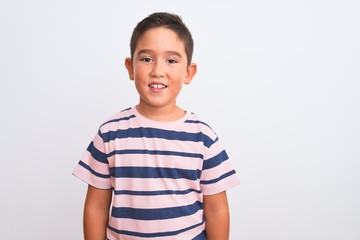 Beautiful kid boy wearing casual striped t-shirt standing over isolated white background with a happy and cool smile on face. Lucky person.