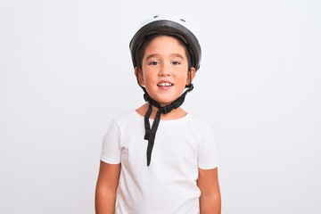 Beautiful kid boy wearing bike security helmet standing over isolated white background with a happy and cool smile on face. Lucky person.