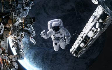 Astronauts, space station in orbit of a deep space planet. Science fiction. Elements of this image...