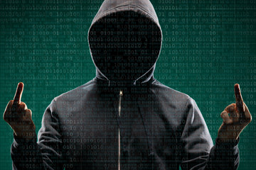 Dangerous hacker over abstract digital background with binary code. Obscured dark face in mask and...