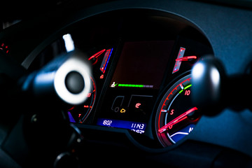 Revolution counter on the control panel of a truck at night