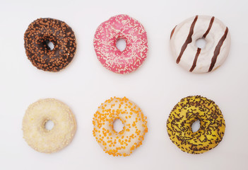 Delicious donuts on light background.