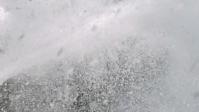 Powerful jet of foam under pressure. Background of splashing white foam.