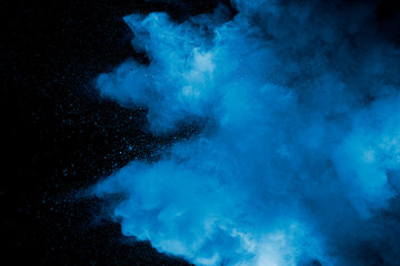 Abstract art blue powder on black background. - 318299001
