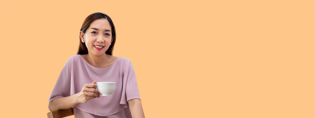 Happy woman female holding and enjoy drinking cup of coffee, looking at camera