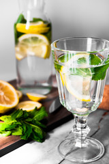Fresh lemonade with mint in a glass jug on a white background