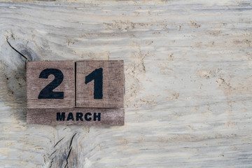 cube calendar for march on wooden background with copy space