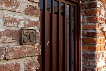 The number 50 on a brick wall.