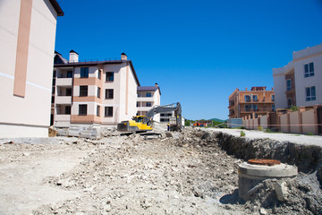A large construction excavator of yellow color on the construction site in a quarry for quarrying