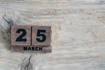 cube calendar for march on wooden background with copy space