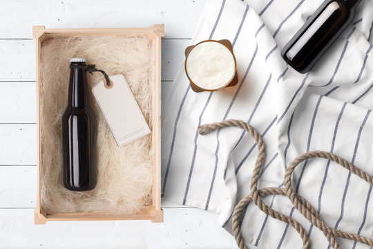 Beer Bottles Composition Mockup In A Wooden Box On White Wooden Background, With Accessories And Blank Label To Place Your Design