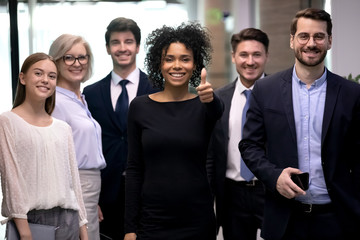 Portrait of excited biracial woman satisfied with company team choice.
