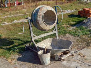 concrete mixer mixes concrete, mortar with a bucket