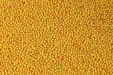 yellow lentils background top view. yellow raw lentils (filling in the picture).