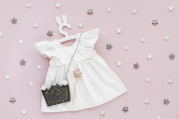 White dress with kids handbag shape of crown on cute hanger with bunny ears. Set of  baby clothes...