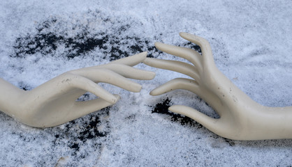 a mannequin hand in the snow