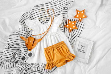 White dress, orange shorts with kids handbag and sunglasses. Set of  baby clothes and accessories...
