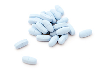 Obraz na płótnie Canvas Blue pills on white background